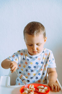 Cute girl eating food at home