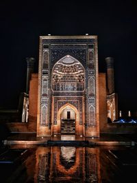 Illuminated mosque against clear sky at night