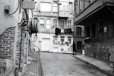 Empty alley amidst buildings in city