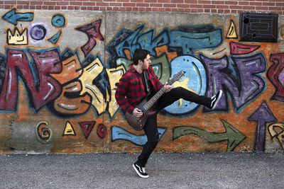 Full frame shot of man with graffiti on wall