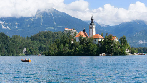 Scenic view of bled lake and buildings against sky