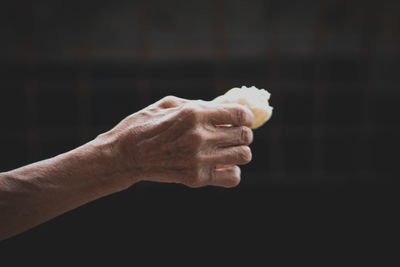 Close-up of hand holding food against blurred background