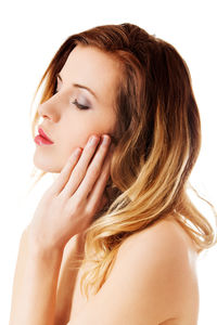 Close-up portrait of a beautiful young woman over white background