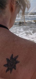 Close-up portrait of woman relaxing on beach