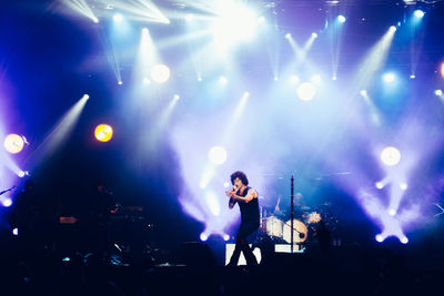 Man singing on stage during concert