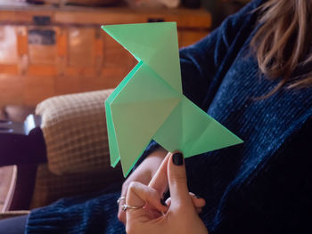 Midsection of woman holding paper toy