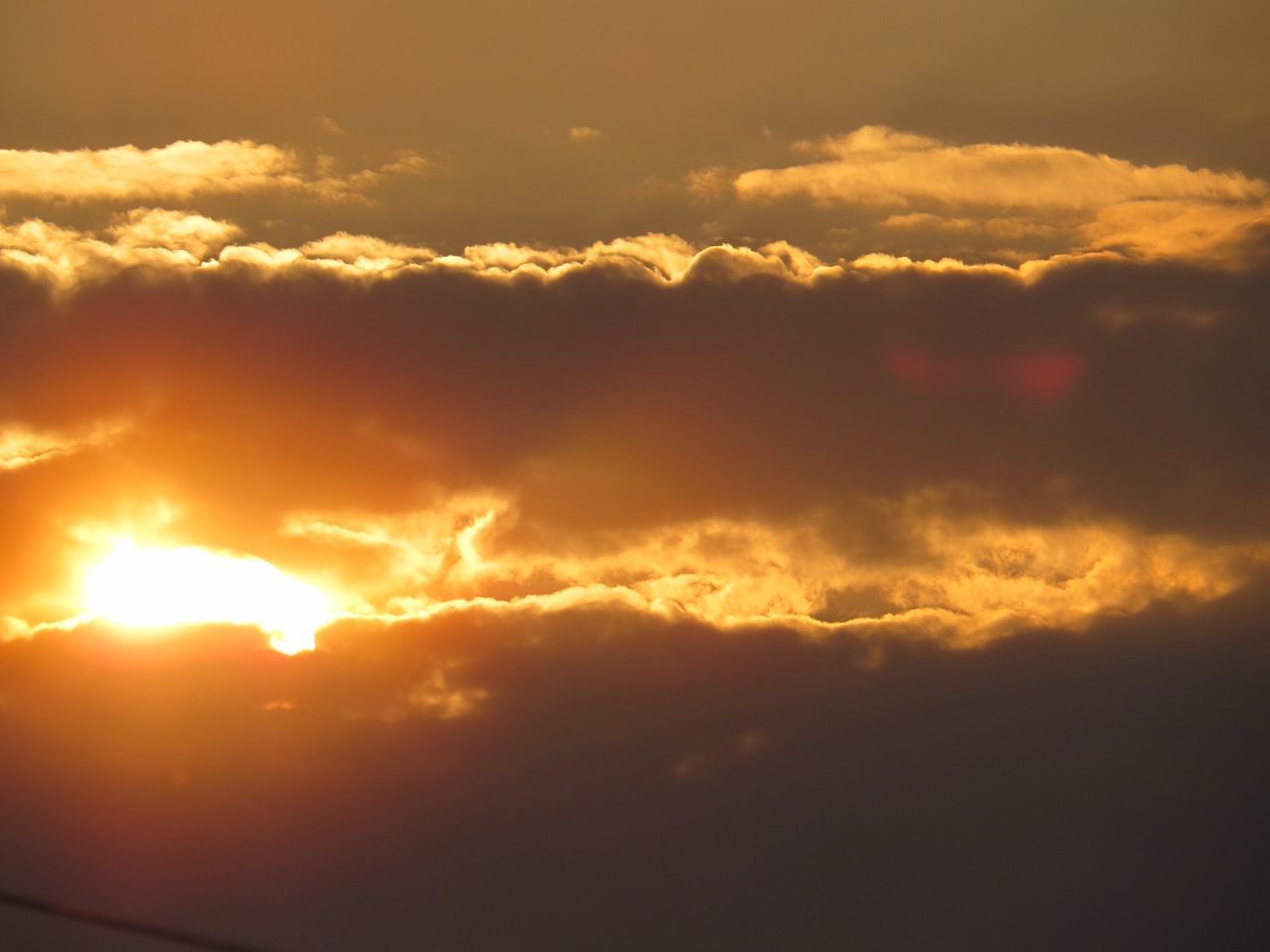 sunset, sky, cloud - sky, scenics, beauty in nature, tranquil scene, tranquility, orange color, sun, cloudy, cloudscape, dramatic sky, idyllic, nature, cloud, majestic, atmospheric mood, low angle view, silhouette, moody sky