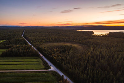 Scenic view of field against sky during sunset