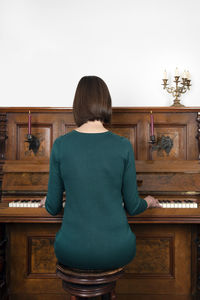 Woman playing piano at home