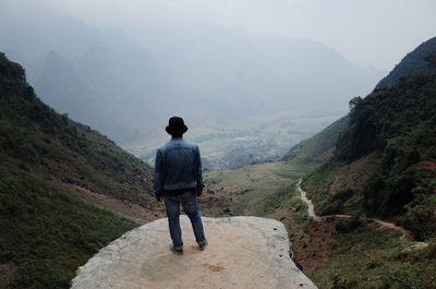 Rear view of man standing on mountain, ha giang, vietnam