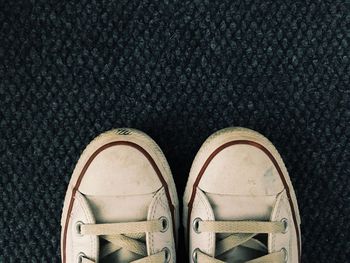 Low section of person standing on tiled floor