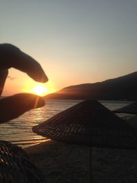 Cropped image of people at sunset