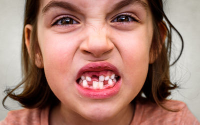 Close-up portrait of girl showing her gap toothed