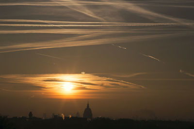 Scenic view of silhouette cross against sky during sunset