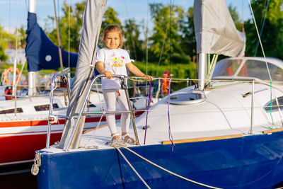 Portrait of cute girl standing on yacht