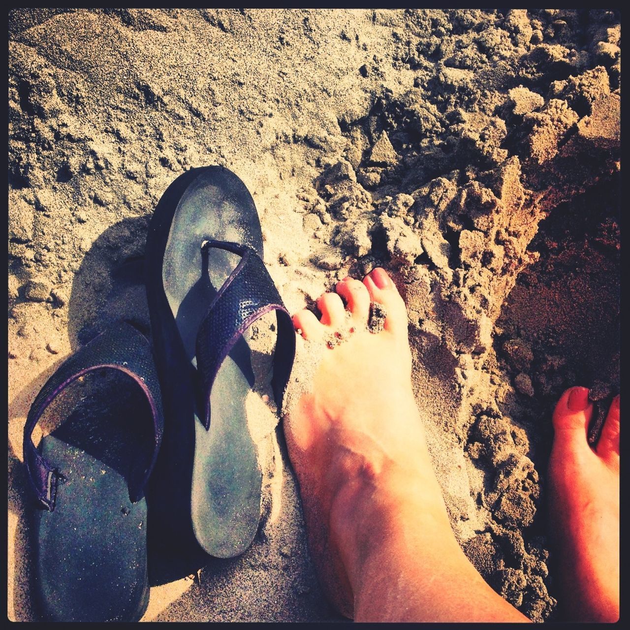 low section, person, transfer print, lifestyles, auto post production filter, personal perspective, high angle view, leisure activity, human foot, shoe, standing, sand, footwear, barefoot, relaxation, shadow