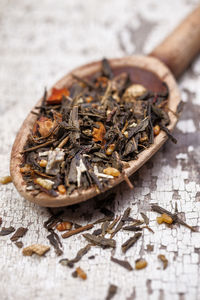 Close-up of herbs on spoon at table