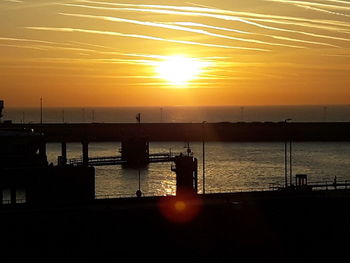 Scenic view of sea against orange sky