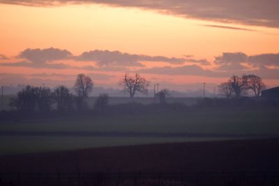 Scenic view of landscape against sky at sunset