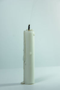 Close-up of illuminated candle on table