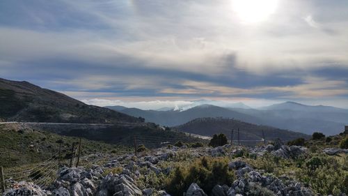 Scenic view of mountains against cloudy sky