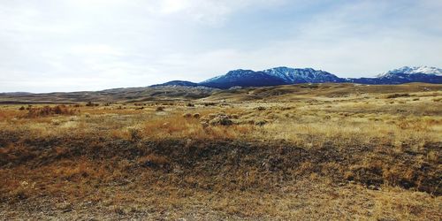 Scenic view of field against sky, mountains montana