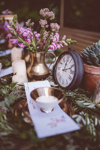 High angle view of old clock amidst plants and flowers