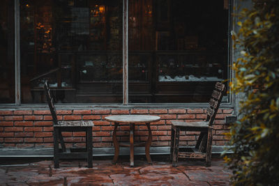 Empty chairs and table in restaurant at night