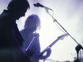 Low angle view of people playing music concert