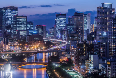 High angle view of city lit up at night