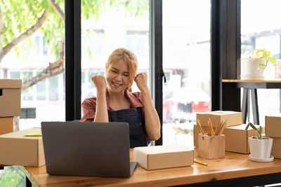 Young woman using laptop on table