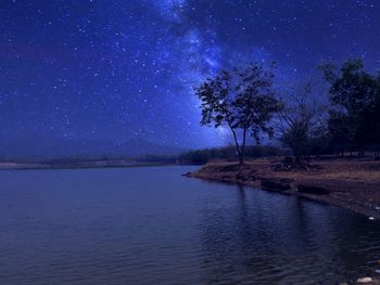 Scenic view of lake against sky at night