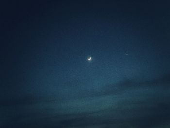 Low angle view of moon in sky at night