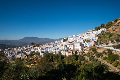 Townscape against clear blue sky