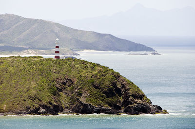 Scenic view of sea and mountain against sky