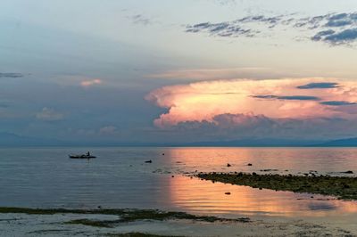 Scenic view of sea against cloudy sky