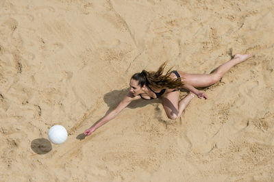 High angle view of woman playing with ball on beach