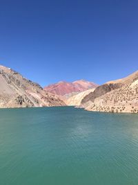 Scenic view of mountains against clear blue sky