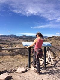 Full length of woman standing at observation point against sky on sunny day