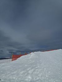 Scenic view of snow covered field against sky