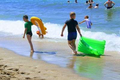 Boys playing in water at beach