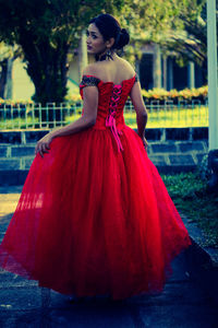 Rear view of young woman wearing red dress