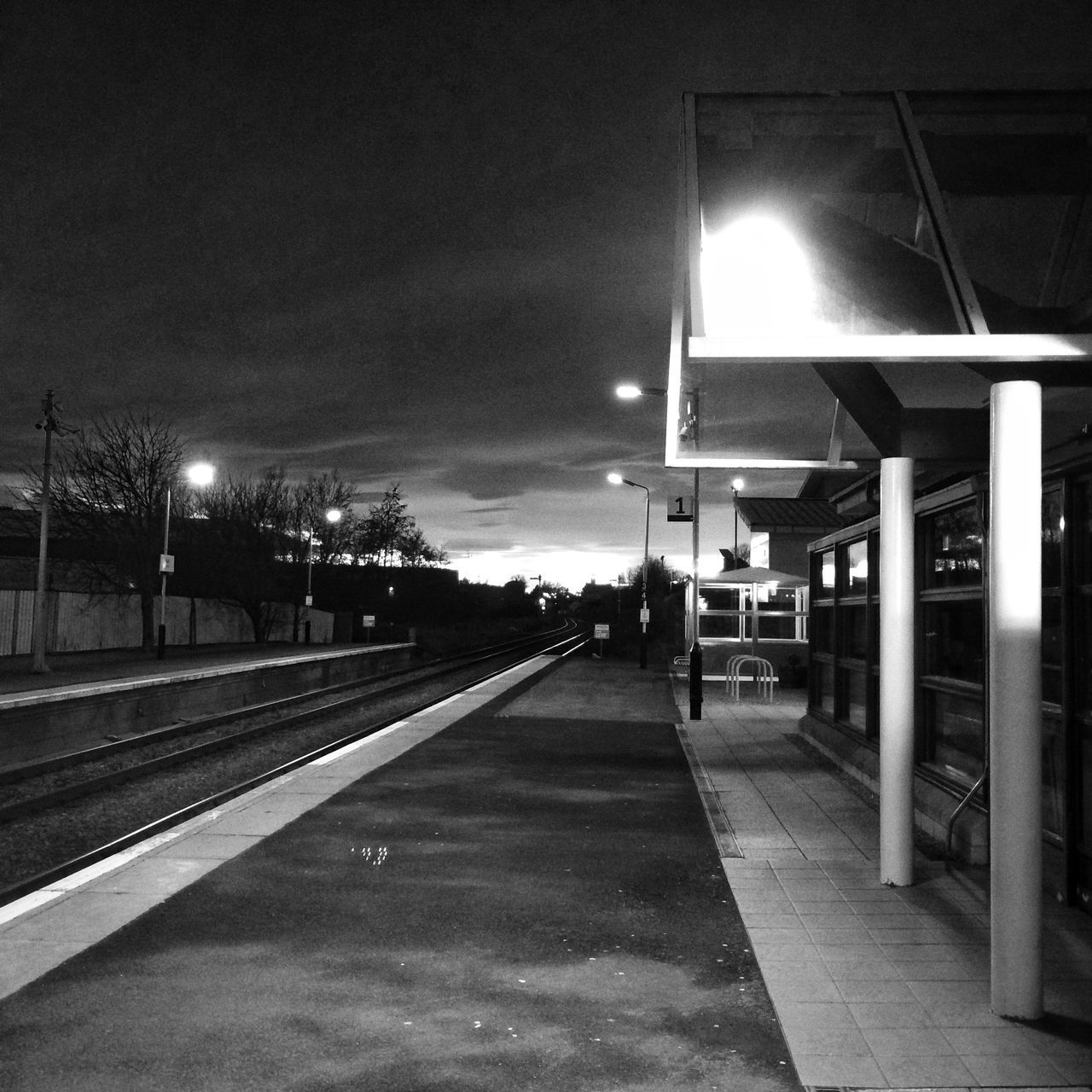 illuminated, night, lighting equipment, street light, the way forward, built structure, architecture, building exterior, empty, transportation, lit, diminishing perspective, sky, railing, vanishing point, electric light, outdoors, incidental people, absence, light - natural phenomenon