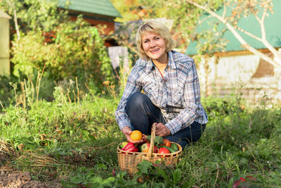 Smiling young woman eating ice cream in basket