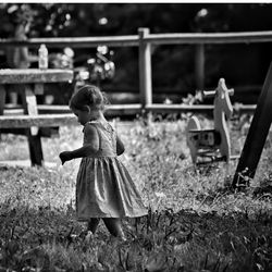 Rear view of girl standing on field