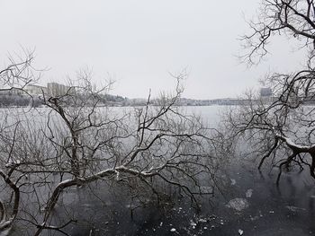 Scenic view of frozen lake against sky during winter