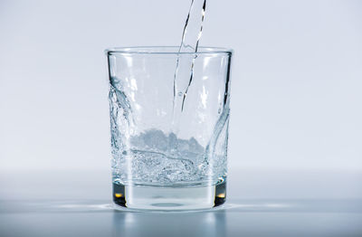 Glass of water against white background