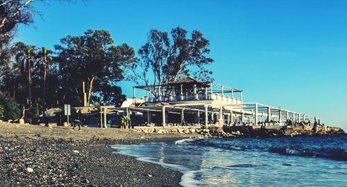 Built structure on beach against clear blue sky