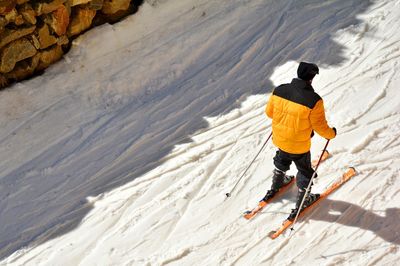 Rear view of man skiing on snow