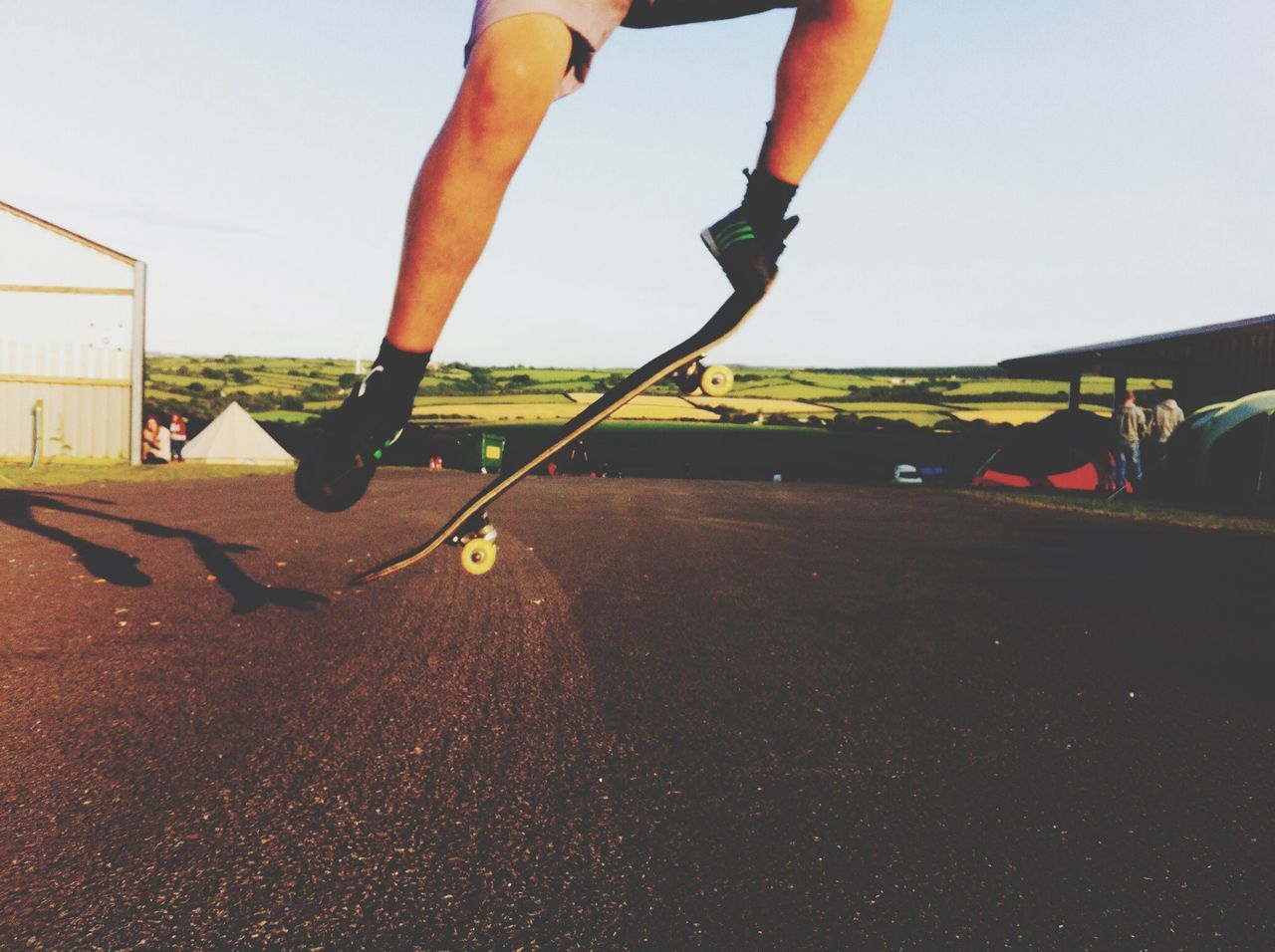 low section, person, lifestyles, leisure activity, men, human foot, road, street, standing, sport, part of, sky, clear sky, sunlight, shoe